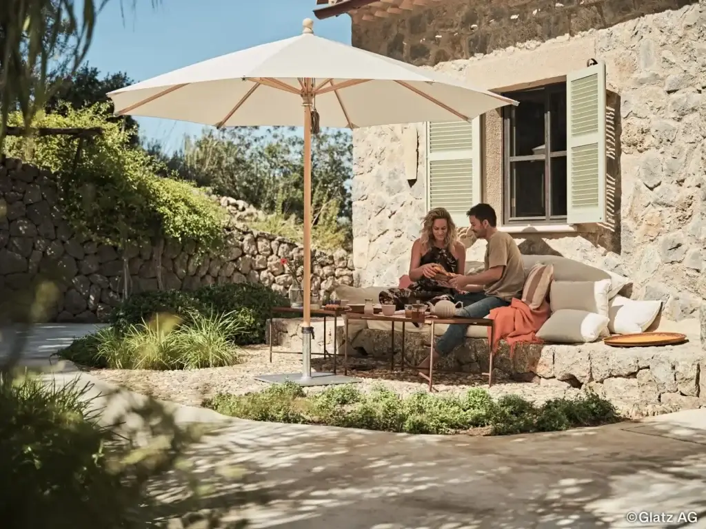 Sonnenschirm von Glatz über einem Sitzplatz im Garten
